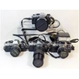 Four 35mm film cameras by Olympus OM10 cameras wit