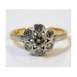 A two colour 18ct gold daisy style ring set with s