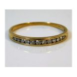 A 9ct gold half eternity ring set with 0.25ct diamonds, size T/U 1.6g