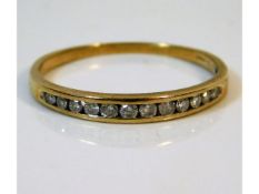 A 9ct gold half eternity ring set with 0.25ct diamonds, size T/U 1.6g