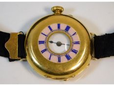 An 18ct gold cased half hunter wrist watch, 32.2mm diameter, total weight 31.3g, ornate monogram to
