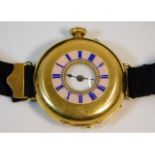 An 18ct gold cased half hunter wrist watch, 32.2mm diameter, total weight 31.3g, ornate monogram to