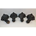 A set of four cast iron bath supports of decorativ