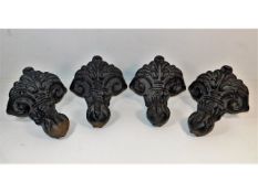 A set of four cast iron bath supports of decorativ