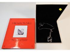 A Swarovski book twinned with a cased Swarovski cr