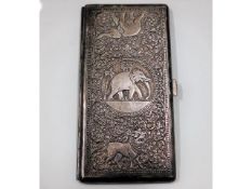 A heavy gauge Indo-Aryan silver cigarette case with elephant & lion decor, initialed to one top corn