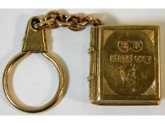 A 9ct gold pill box depicting book with fob made b