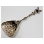An ornate 0.900 silver spoon with windmill finial