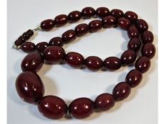 A vintage set of graduated cherry amber style beaded necklace, 21.5in long 63.3g, largest bead 26.9m