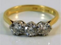 An 18ct gold trilogy ring set with approx. 1ct diamond size M/N 3g