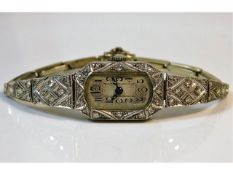 A 1940's platinum cased ladies cocktail wristwatch set with approx. 29 diamonds, runs when wound, 16