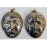 Two silver mask pendants made by the late Cornish