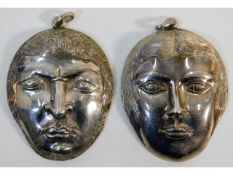 Two silver mask pendants made by the late Cornish
