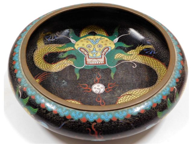 A Chinese cloisonne bowl with dragon chasing flami