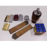 A wooden table lighter, other lighters, two rules