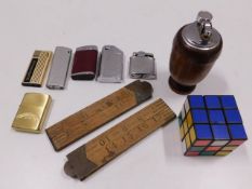 A wooden table lighter, other lighters, two rules