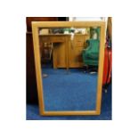 An Ercol wall mirror with bevelled glass, 37in x 2