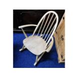 An Ercol elm seated childs rocking chair, later st