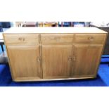 An Ercol elm sideboard with three drawers & cupboa