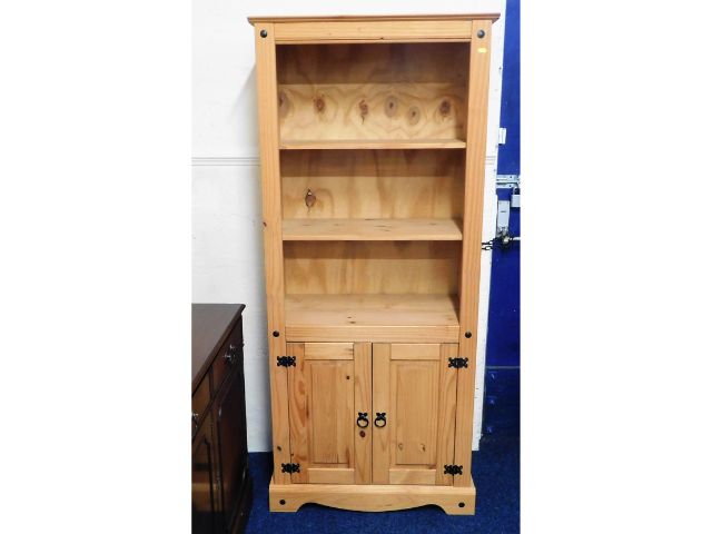 A modern pine bookcase with cupboard under, 72in t