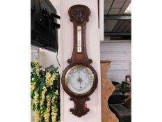 An oak cased aneroid barometer 35in high