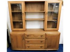 A retro styled Ercol elm wall cabinet with cupboar