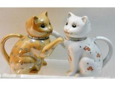 A pair of Chinese porcelain 'lucky cat' teapots