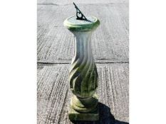 A weathered stone pedestal 40.5in high with bronze