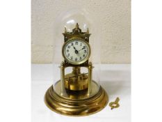 A 20thC. brass anniversary clock mounted on plasti