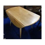 An Ercol elm drop leaf dining table, 49.75in exten