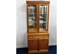 A teak style mirrored back lit display cupboard wi