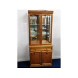 A teak style mirrored back lit display cupboard wi