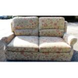 A modern two seater sofa with fire labels 76in wid