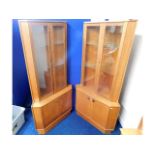 A pair of Turnidge of London teak corner display c