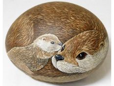 A hand painted large pebble depicting otter & cub