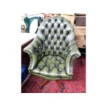 A leather Chesterfield style swivel bucket chair,