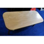 An oak coffee table, fault with one leg 36.25in lo
