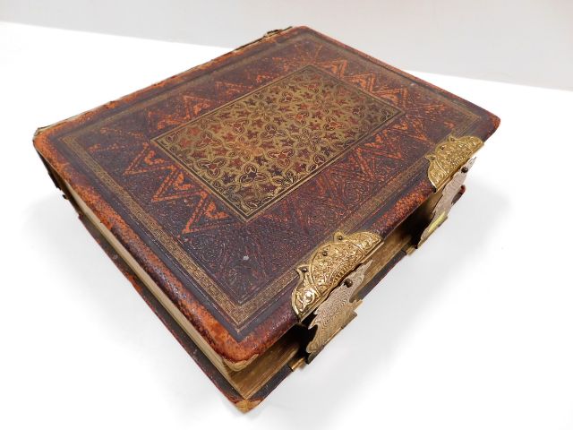 A 19thC. leather bound family bible with brass fit