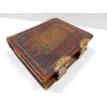 A 19thC. leather bound family bible with brass fit