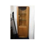 An Ercol elm corner display cabinet with lighting, 76.75in tall x 28.25in at widest x 185in deep, sc