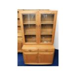 A retro styled Ercol elm bookcase & cupboard, 63.5