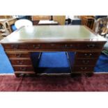 A large pedestal desk with nine drawers with key,