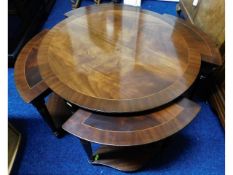 A modern mahogany circular table nest, 29in diamet