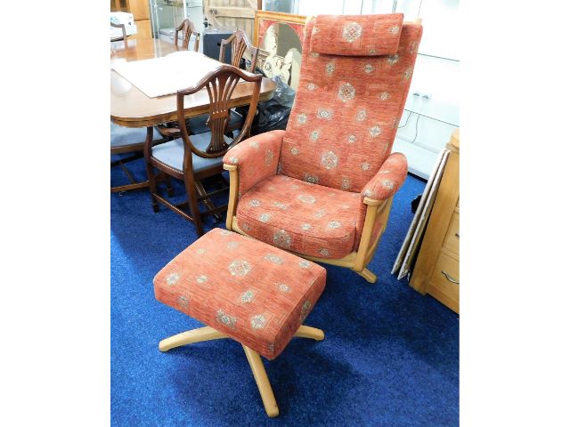 An Ercol swivel armchair with matching footstool,