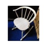An Ercol elm seated rocking chair, later stripped