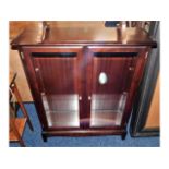 A modern mahogany display cabinet with glass shelv