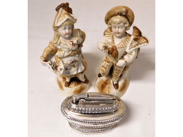 A pair of Conta & Boehme figures twinned with a Ronson table lighter a/f