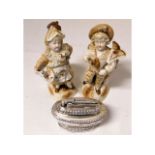 A pair of Conta & Boehme figures twinned with a Ronson table lighter a/f