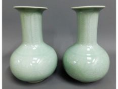 A pair of 20thC. celadon vases with foliate decor,