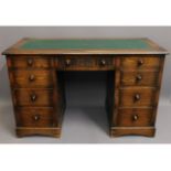 A 20thC. oak desk with nine drawers, 30.25in high